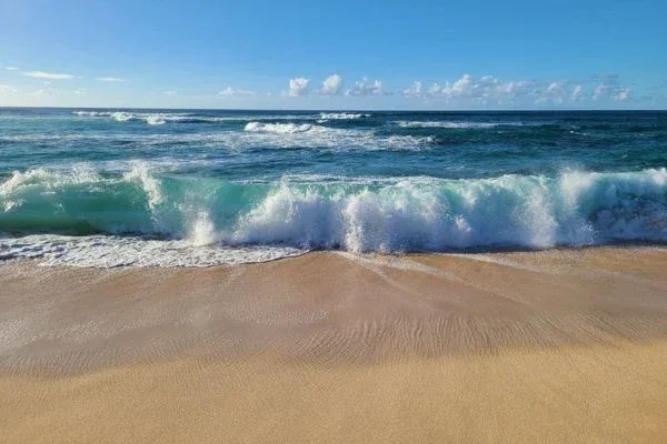 Close-up of a crashing wave at Sunset Beach Park, showcasing the power and beauty of the ocean.